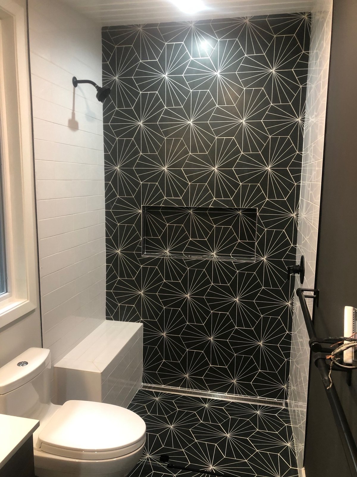 Modern bathroom with geometric patterned black and white tiles
