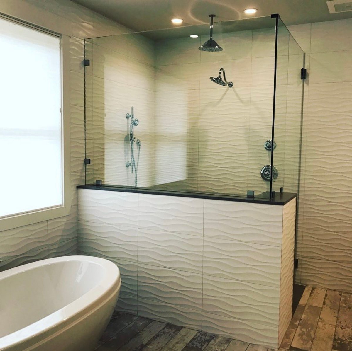 Modern bathroom with freestanding tub and large walk-in shower
