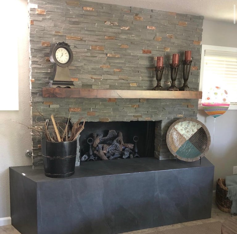 Modern fireplace with gray slate tile surround and wooden mantel